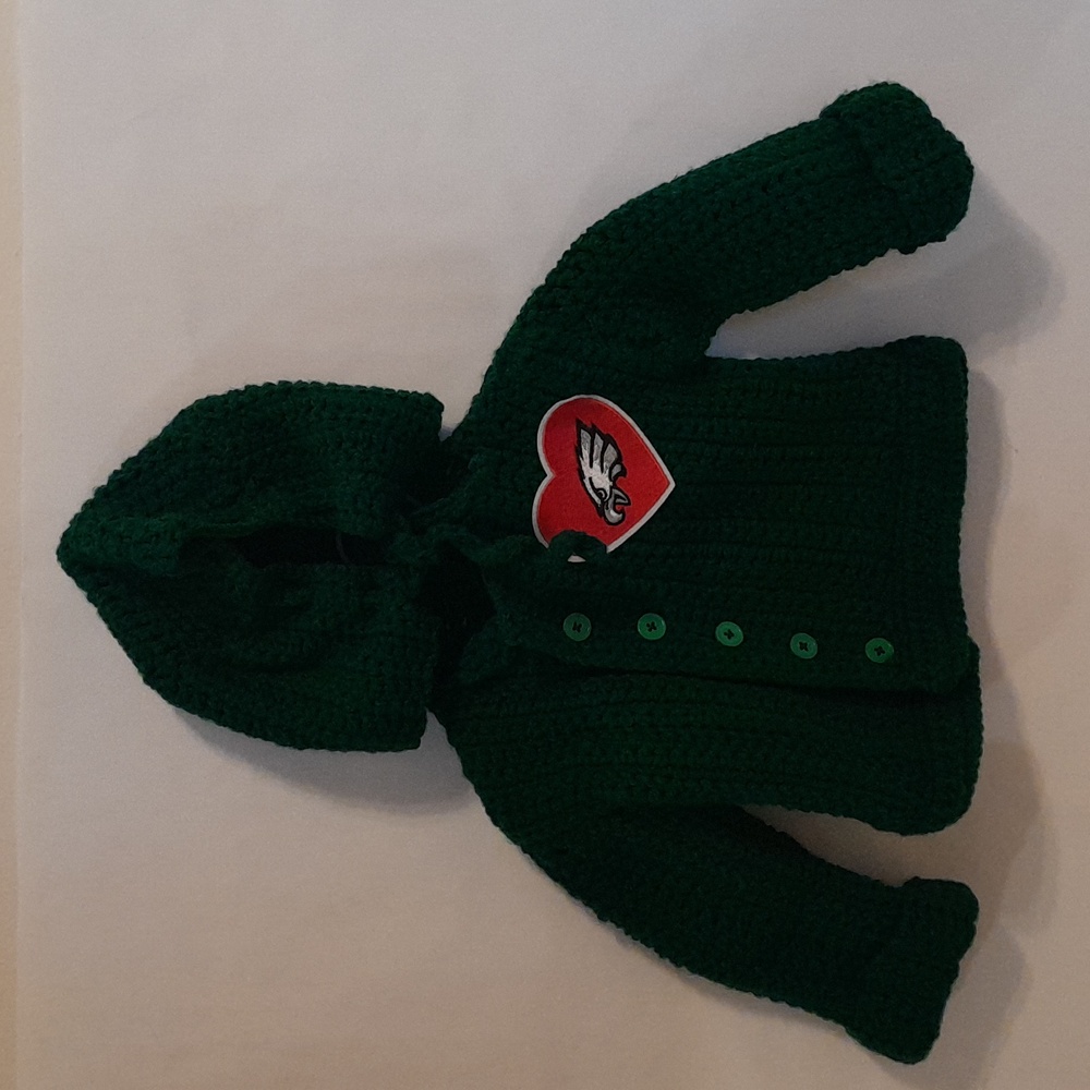 A emerald green baby hoodie.